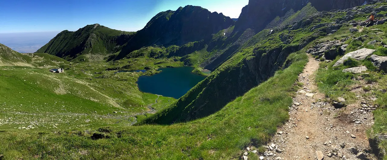 Wide alpine view across the Fagaras ridge and Podragu area under broken cloud