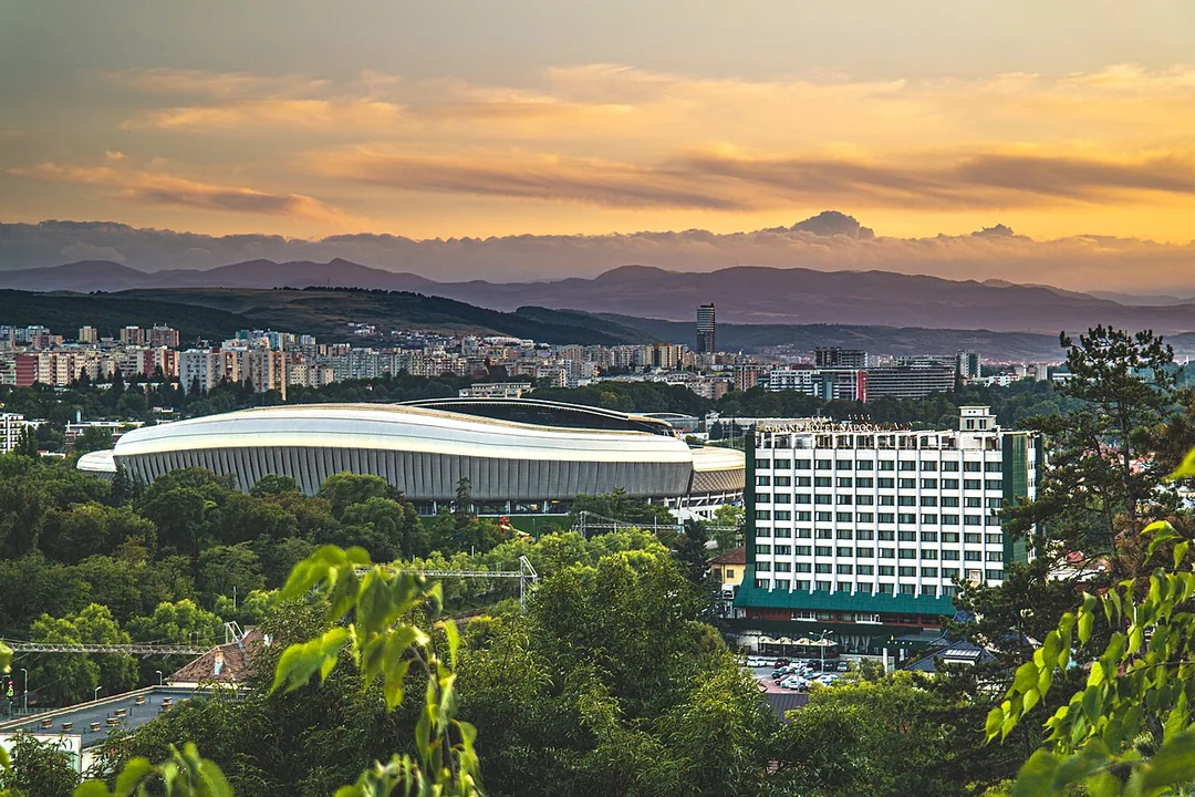 View over the rooftops of Cluj-Napoca at sunset, the spread of the city and its surrounding hills