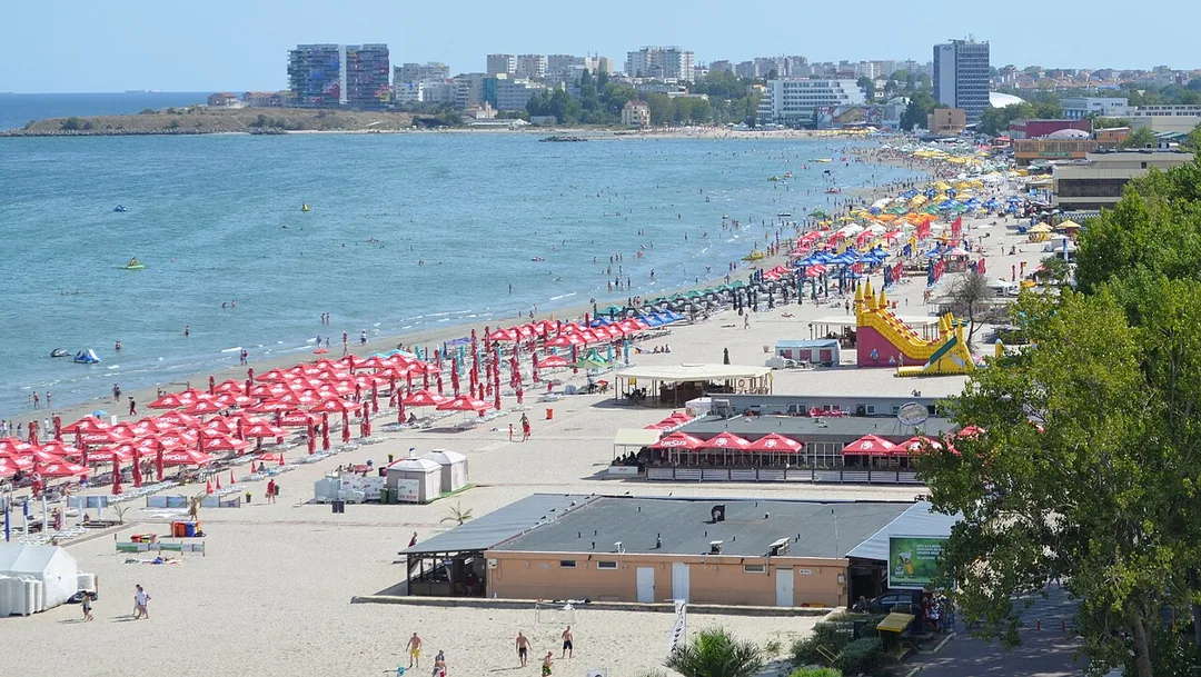The wide sandy beach at Mamaia lined with hotels, sunbeds and umbrellas under a summer sky