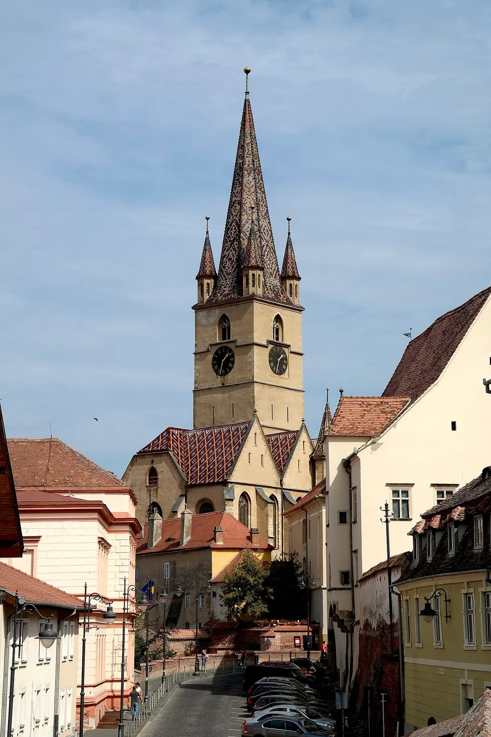 The Gothic tower and spire of the Lutheran Cathedral of Saint Mary rising over Piata Huet in the Upper Town of Sibiu