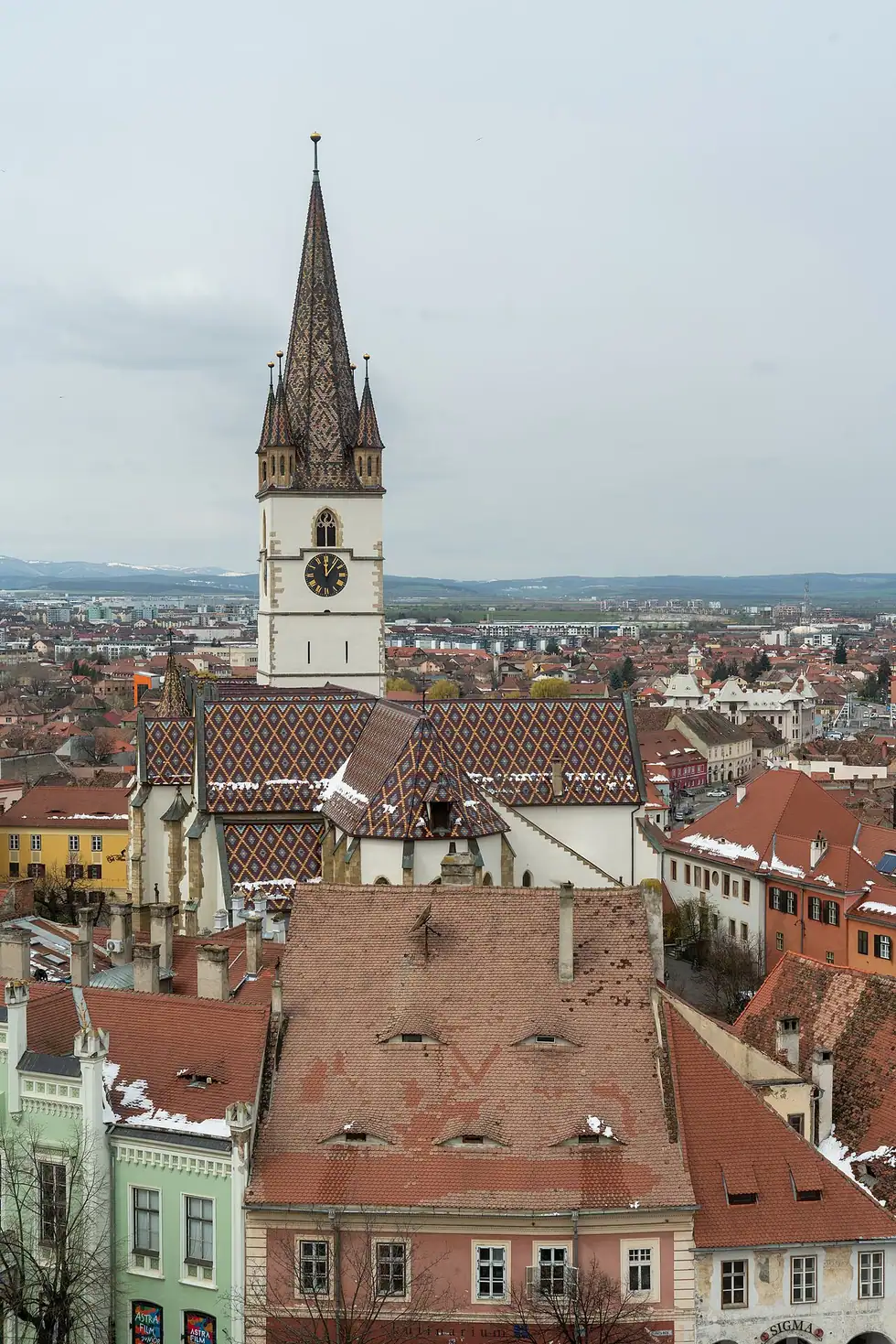 The rooftops of Sibiu with their distinctive eyelid dormer windows, the Lutheran Cathedral spire rising behind
