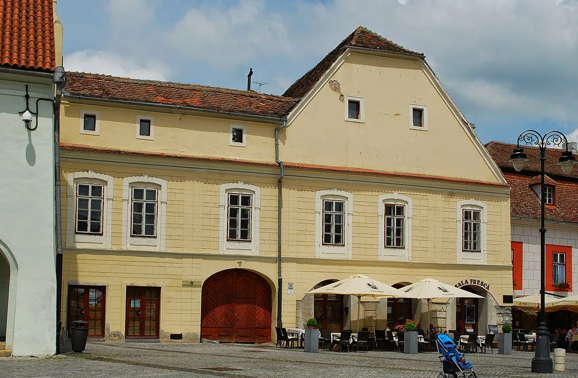 Colourful historic buildings with cafe terraces lining Piata Mica, the Small Square in the Upper Town of Sibiu
