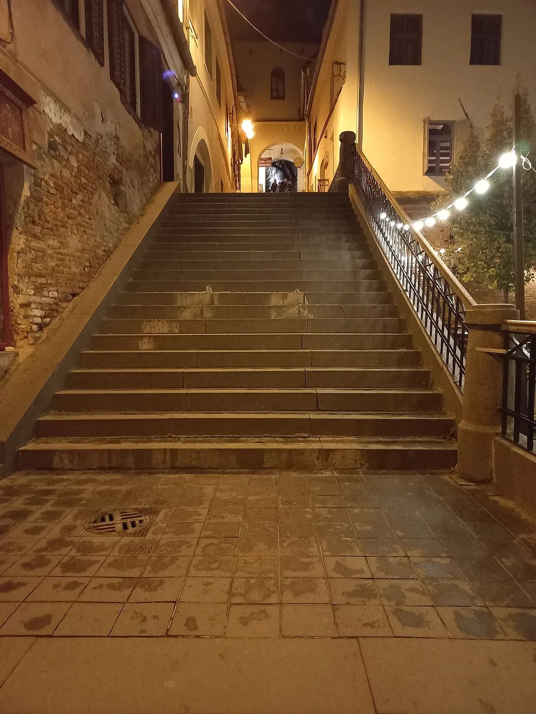 A covered stone stair passage in Sibiu descending from Piata Huet in the Upper Town down towards the Lower Town