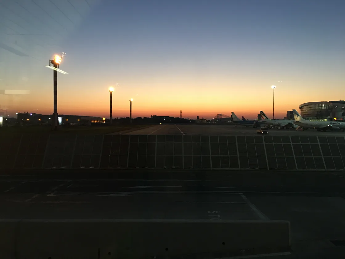 The exterior forecourt of Bucharest Henri Coanda airport, cars and a taxi rank in front of the terminal, the main international gateway to Romania